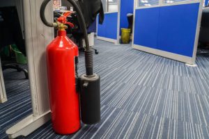 red fire extinguisher in office for safety